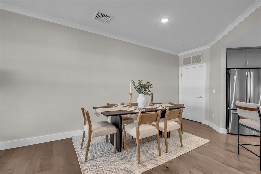 55 Pointe Place, Unit 306 Dover, NH 03820 - Photo 11 of 41 a view of a dining room with furniture and wooden floor