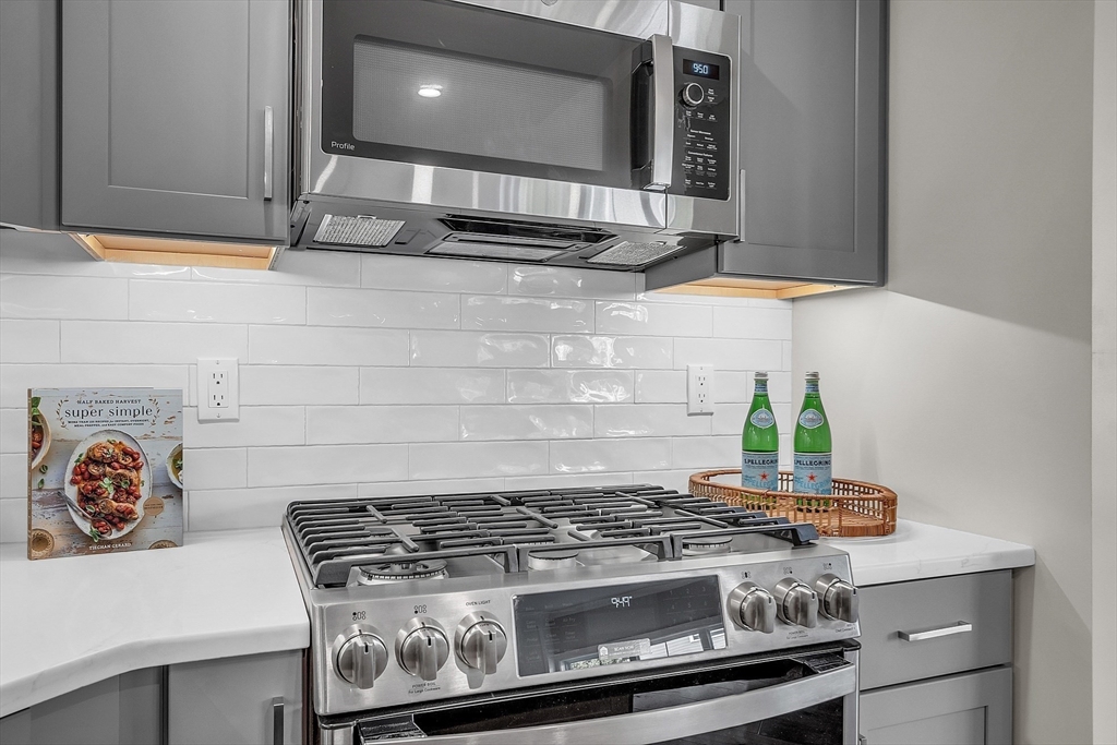 55 Pointe Place, Unit 306 Dover, NH 03820 - Photo 9 of 41 a stove top oven sitting inside of a kitchen