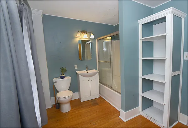 a view of empty room with wooden floor