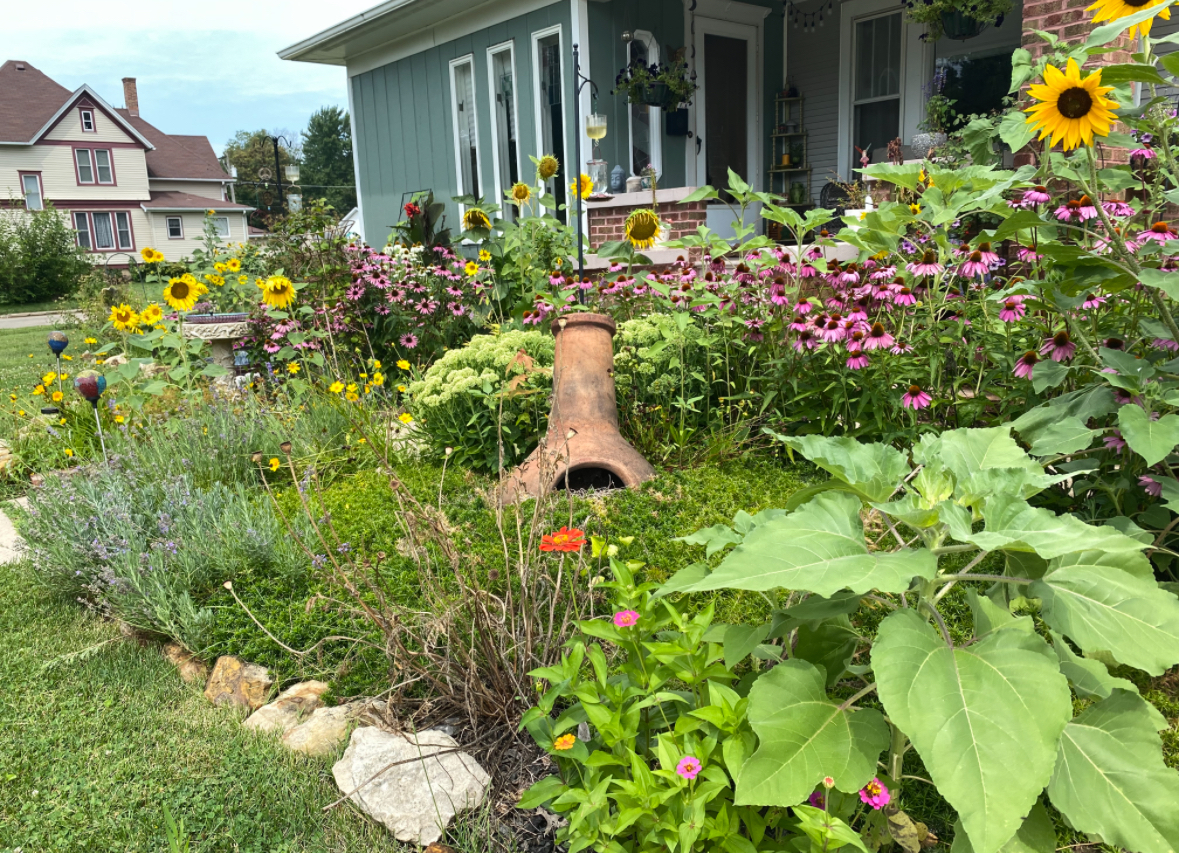 210 6th Street Mendota, IL 61342 - Photo 25 of 27 front view of a house with a yard and flowers