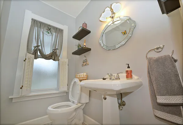 a bathroom with a sink toilet and mirror