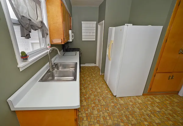 a kitchen with a refrigerator and a sink