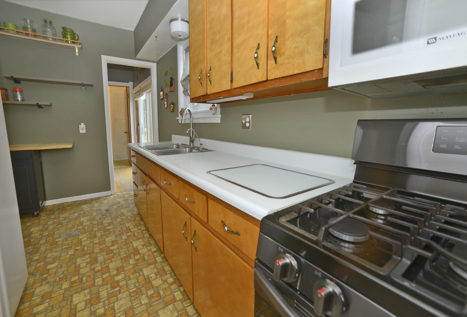 210 6th Street Mendota, IL 61342 - Photo 9 of 27 a kitchen with a stove and a sink