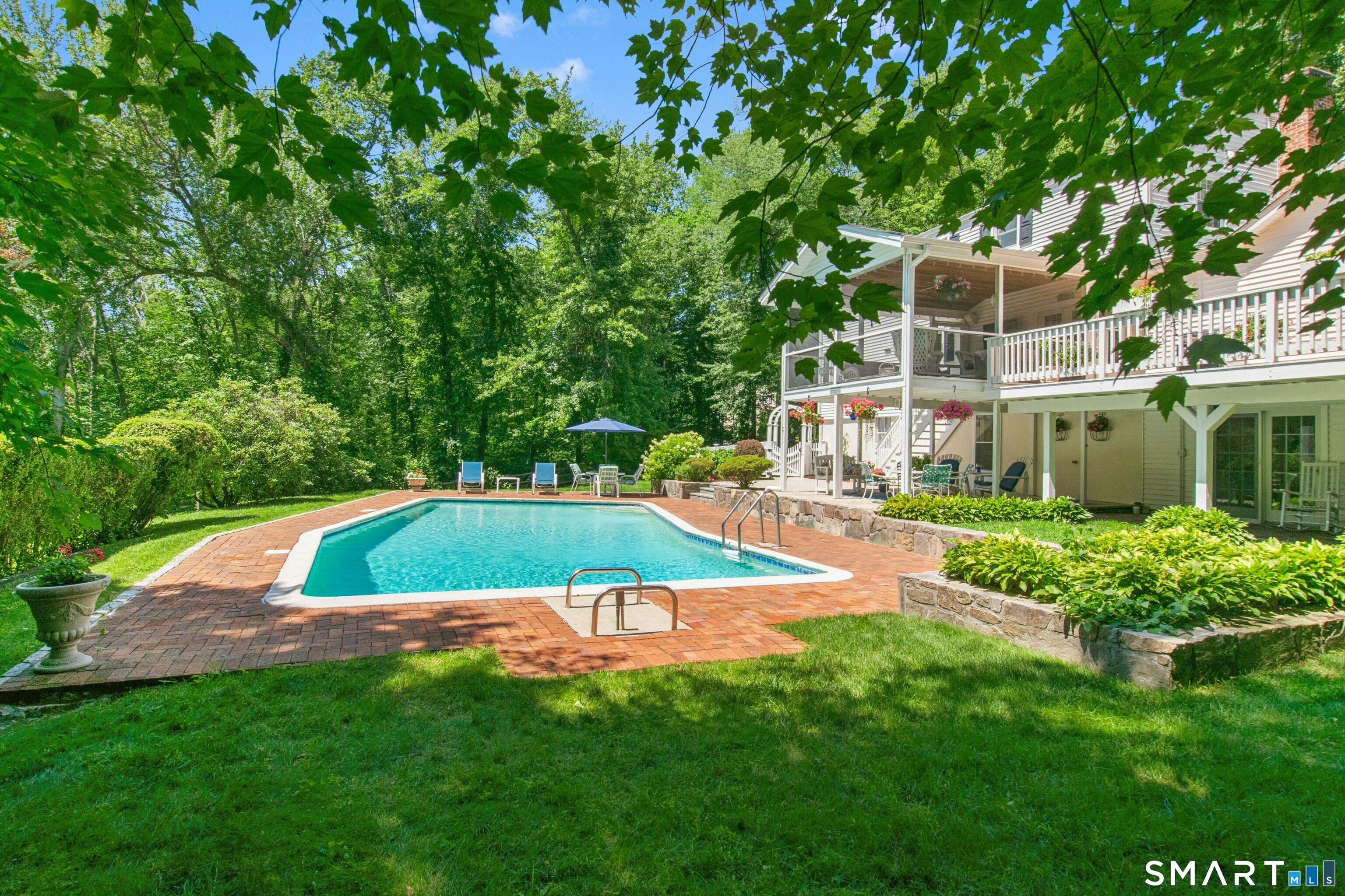 47 Pine Ridge Road Wilton, CT 06897 - Photo 6 of 40 The alive backyard buzzing with activity and kids swimming or playing on the open patios can be visually monitored from the kitchen windows, the open deck, screened-in porch and poolside areas - all designed to give the parents total peace of mind.