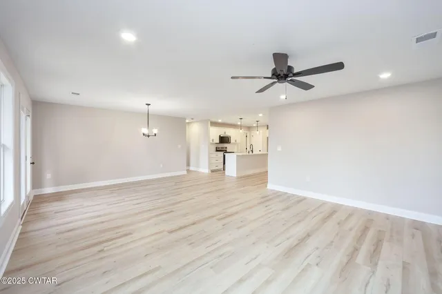 a view of a kitchen with a sink and wooden floor