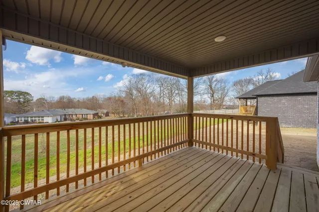 a view of balcony with wooden floor