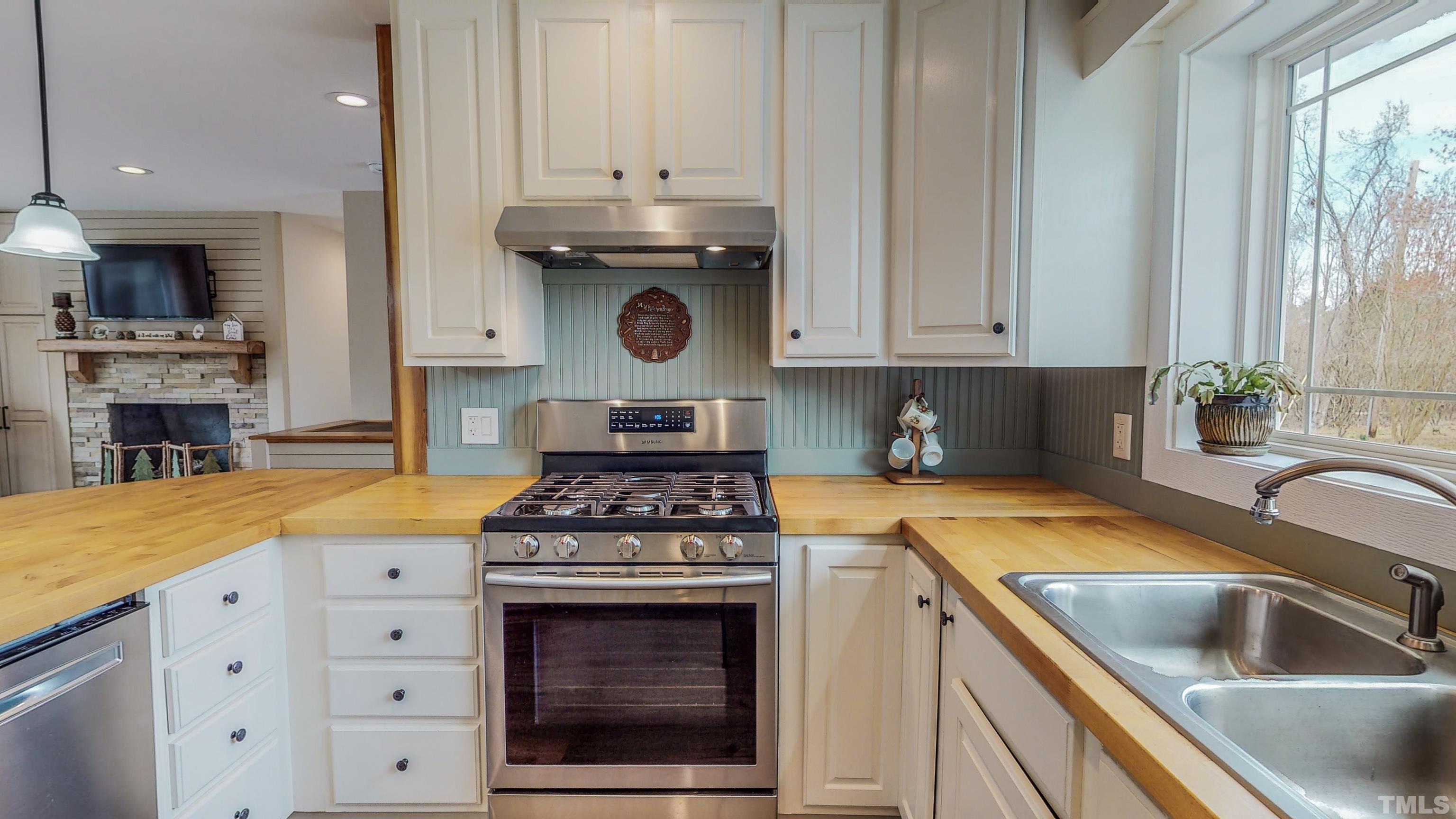 155 Alva Oakley Road Roxboro, NC 27574 - Photo 15 of 42 a kitchen with a stove and a sink