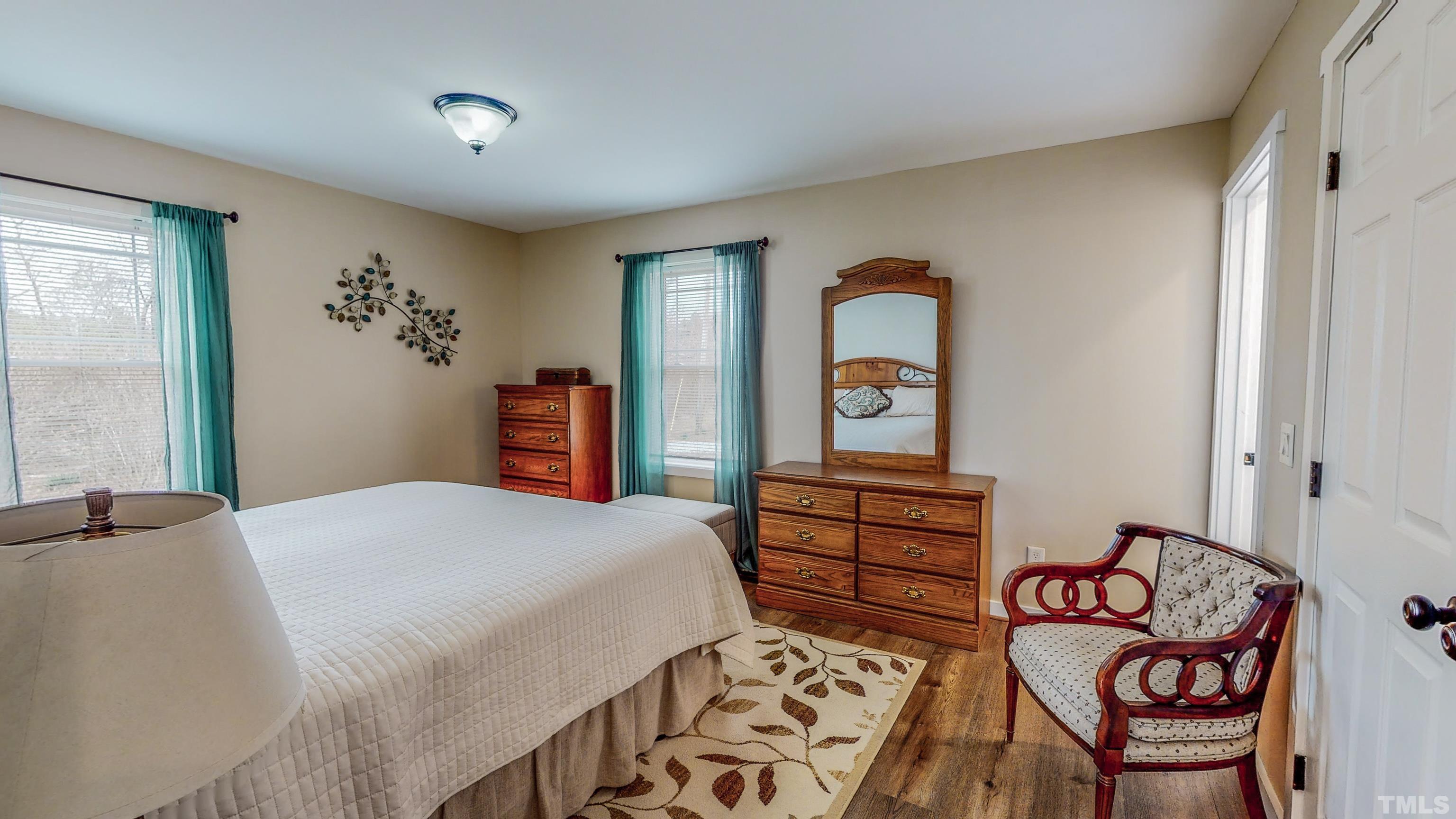 155 Alva Oakley Road Roxboro, NC 27574 - Photo 21 of 42 a bedroom with a bed and a dresser in it