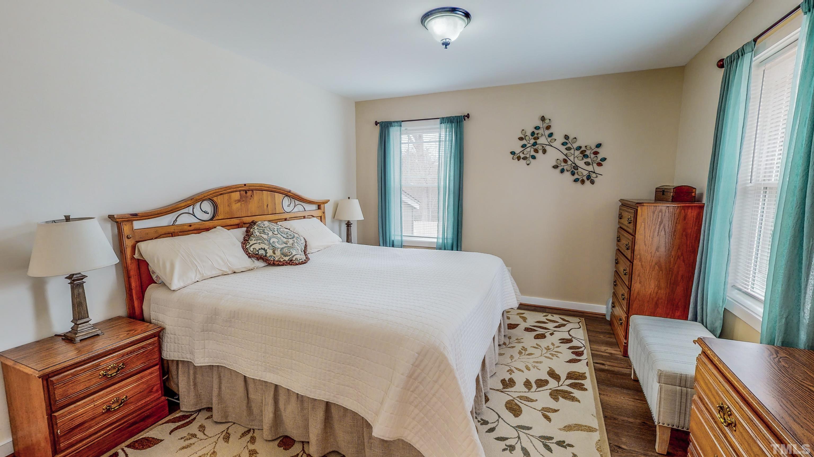 155 Alva Oakley Road Roxboro, NC 27574 - Photo 22 of 42 a bedroom with a bed and wooden floor