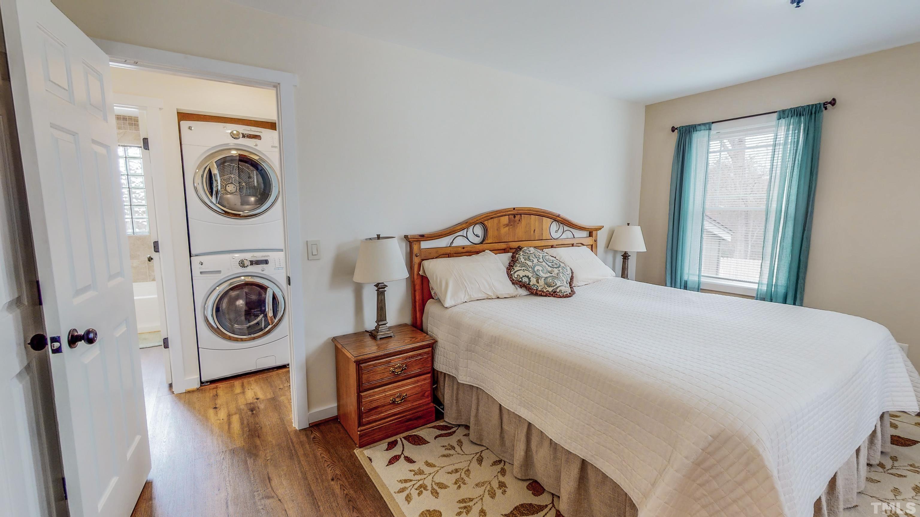 155 Alva Oakley Road Roxboro, NC 27574 - Photo 23 of 42 a bedroom with a bed a washer and dryer
