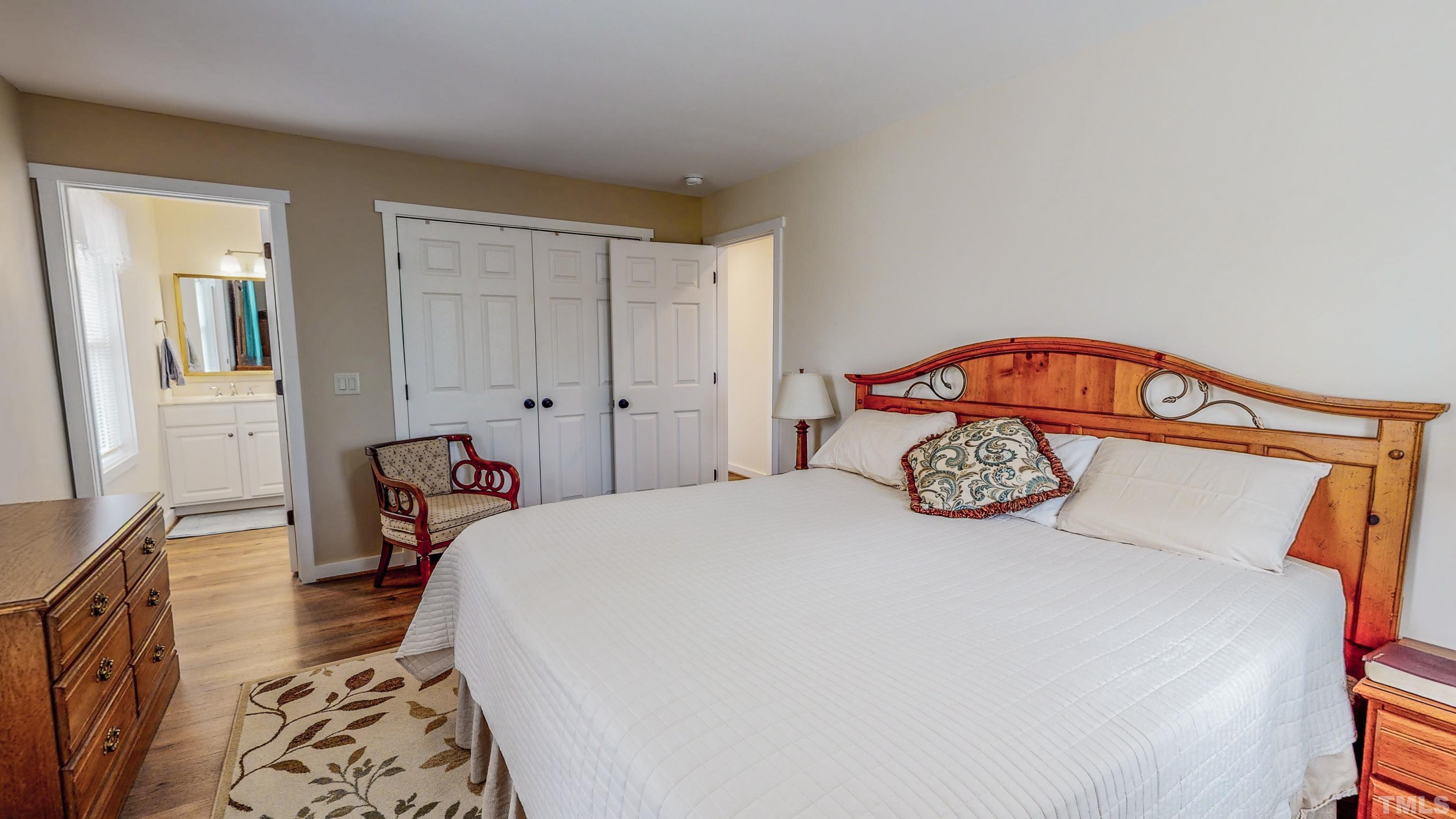 155 Alva Oakley Road Roxboro, NC 27574 - Photo 24 of 42 a bedroom with a bed and a lamp on dresser