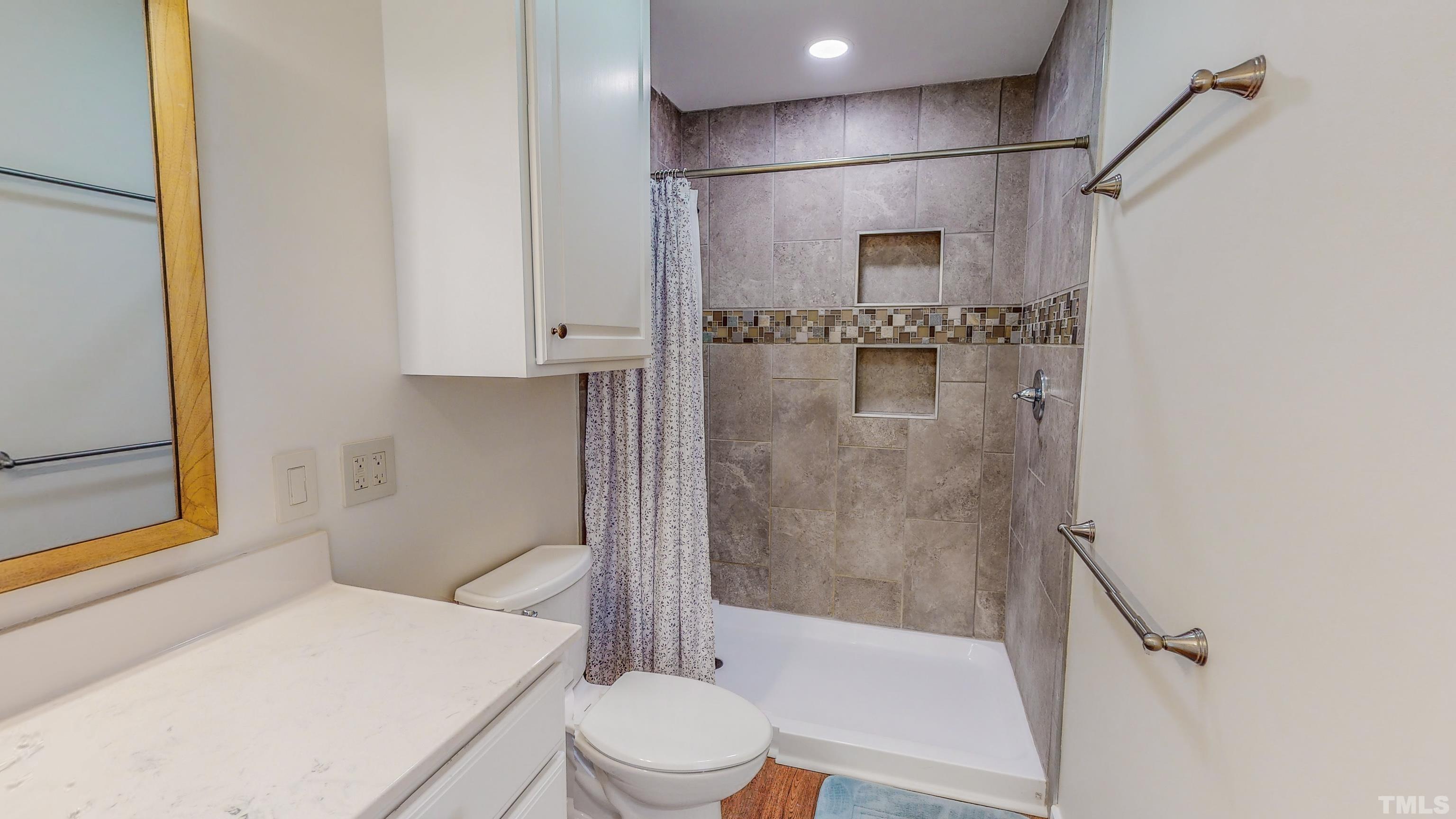 155 Alva Oakley Road Roxboro, NC 27574 - Photo 26 of 42 a bathroom with a sink toilet and shower