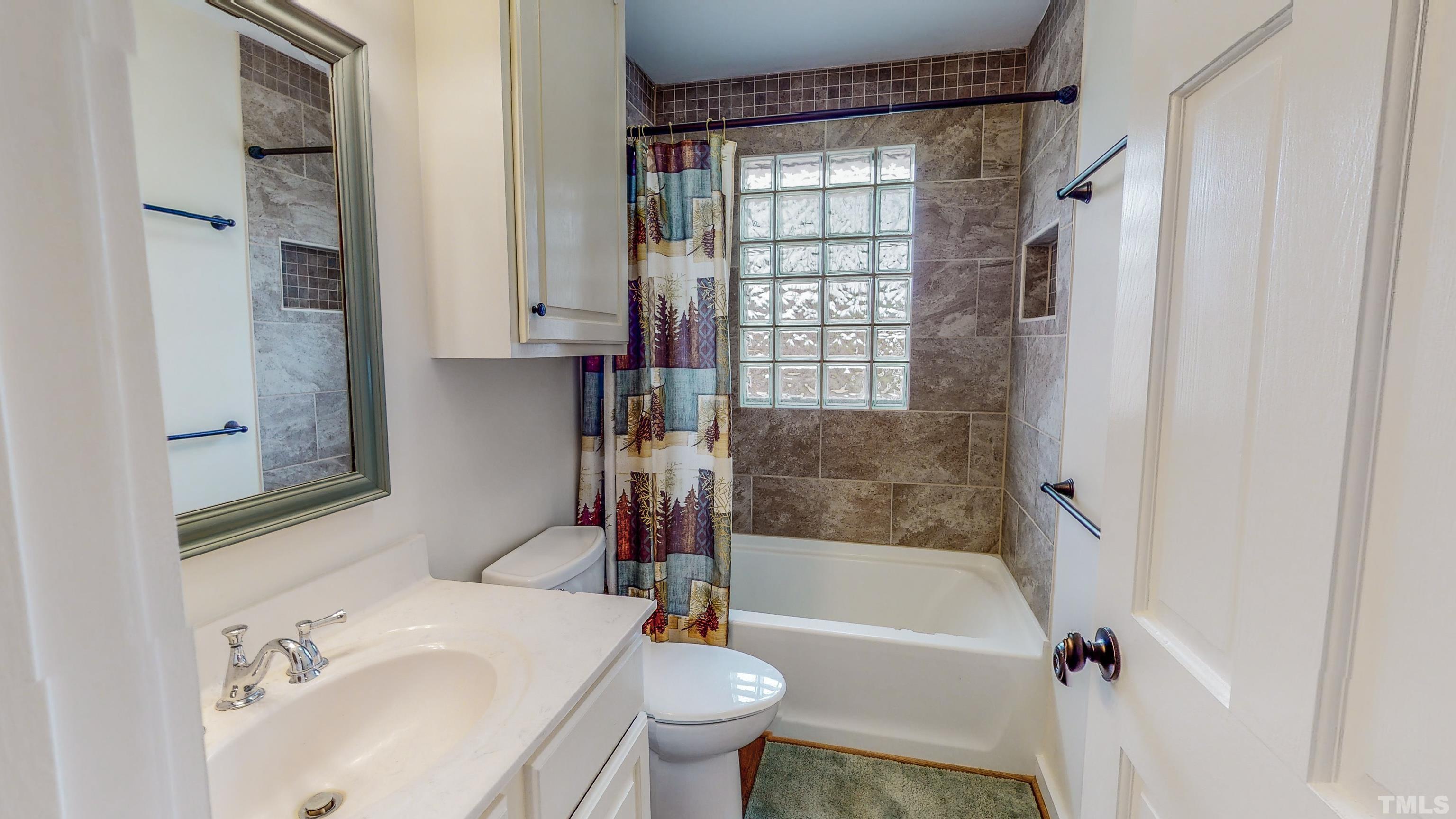 155 Alva Oakley Road Roxboro, NC 27574 - Photo 28 of 42 a bathroom with a sink toilet and shower