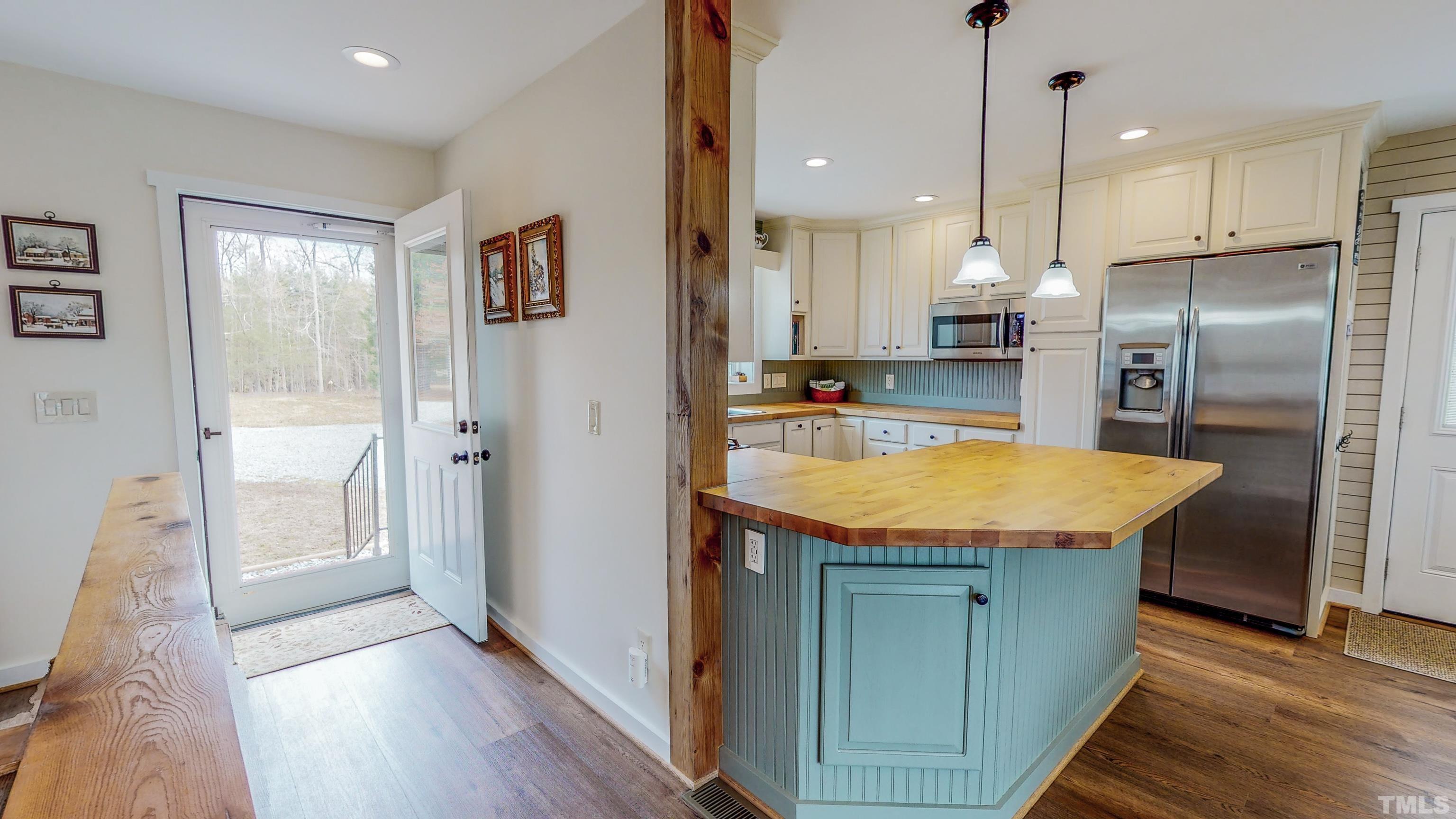 155 Alva Oakley Road Roxboro, NC 27574 - Photo 32 of 42 a kitchen with stainless steel appliances granite countertop a refrigerator a sink and a stove