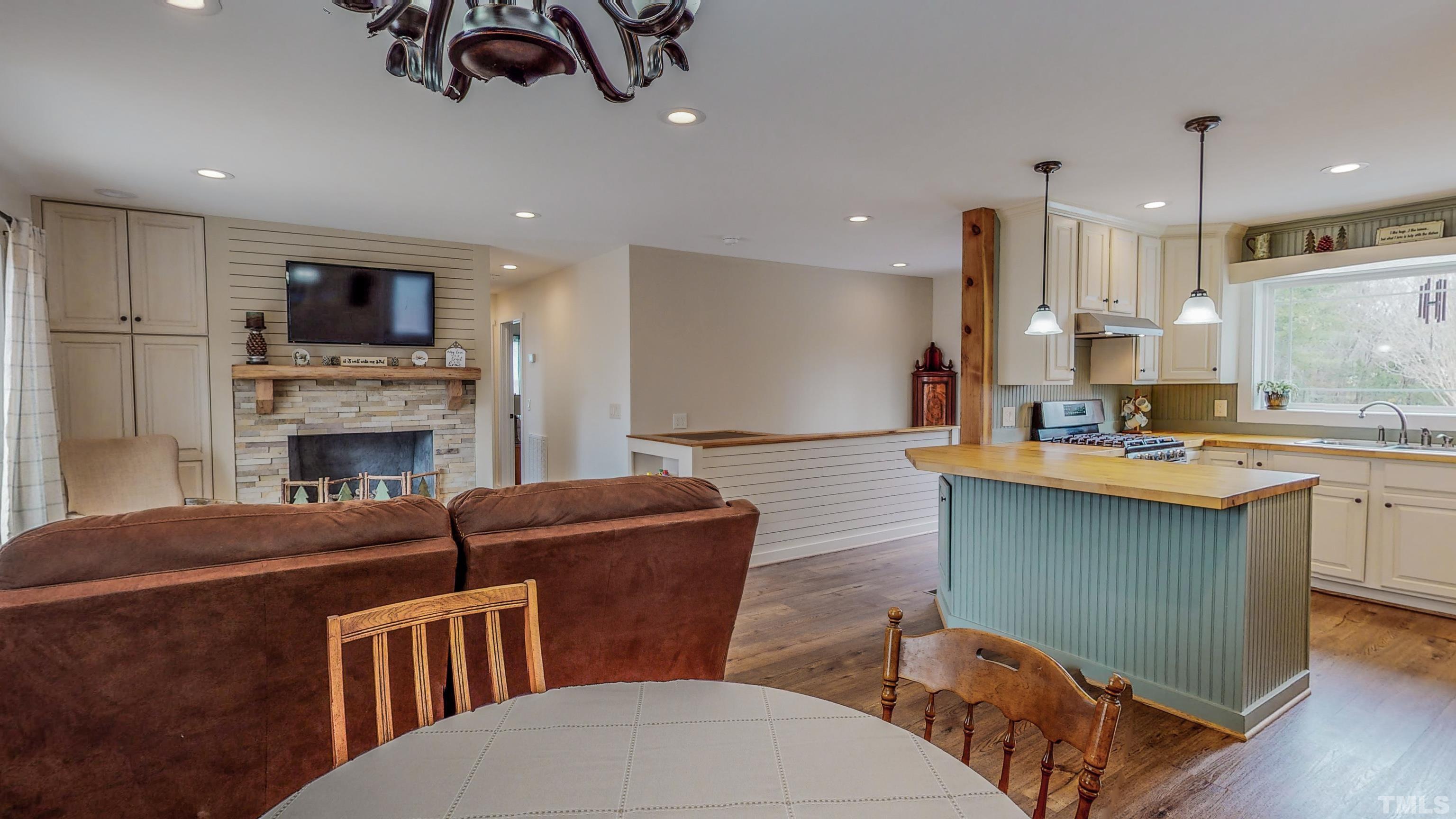 155 Alva Oakley Road Roxboro, NC 27574 - Photo 35 of 42 a living room with furniture a flat screen tv and kitchen view