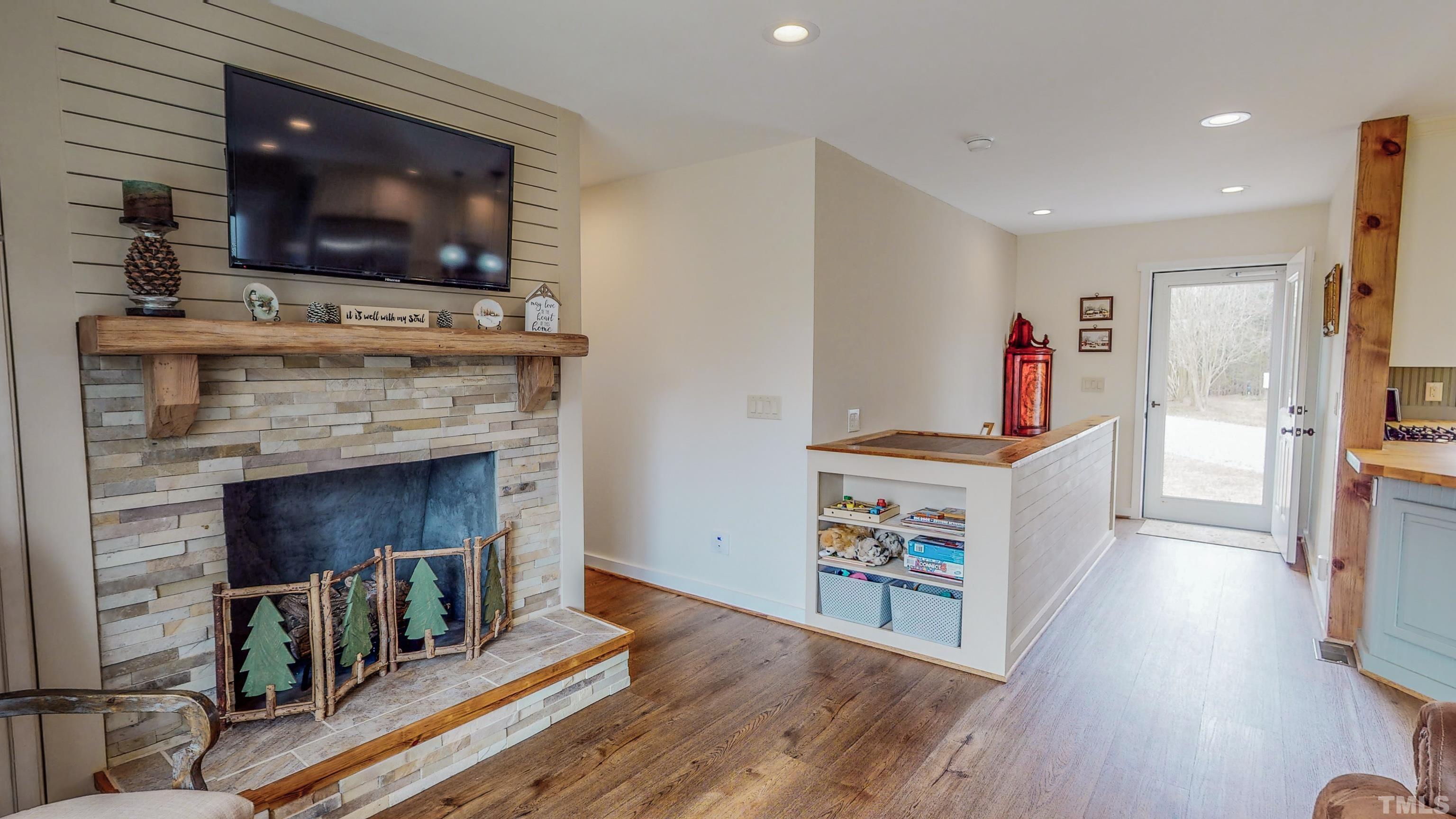 155 Alva Oakley Road Roxboro, NC 27574 - Photo 5 of 42 a living room with furniture fireplace and flat screen tv