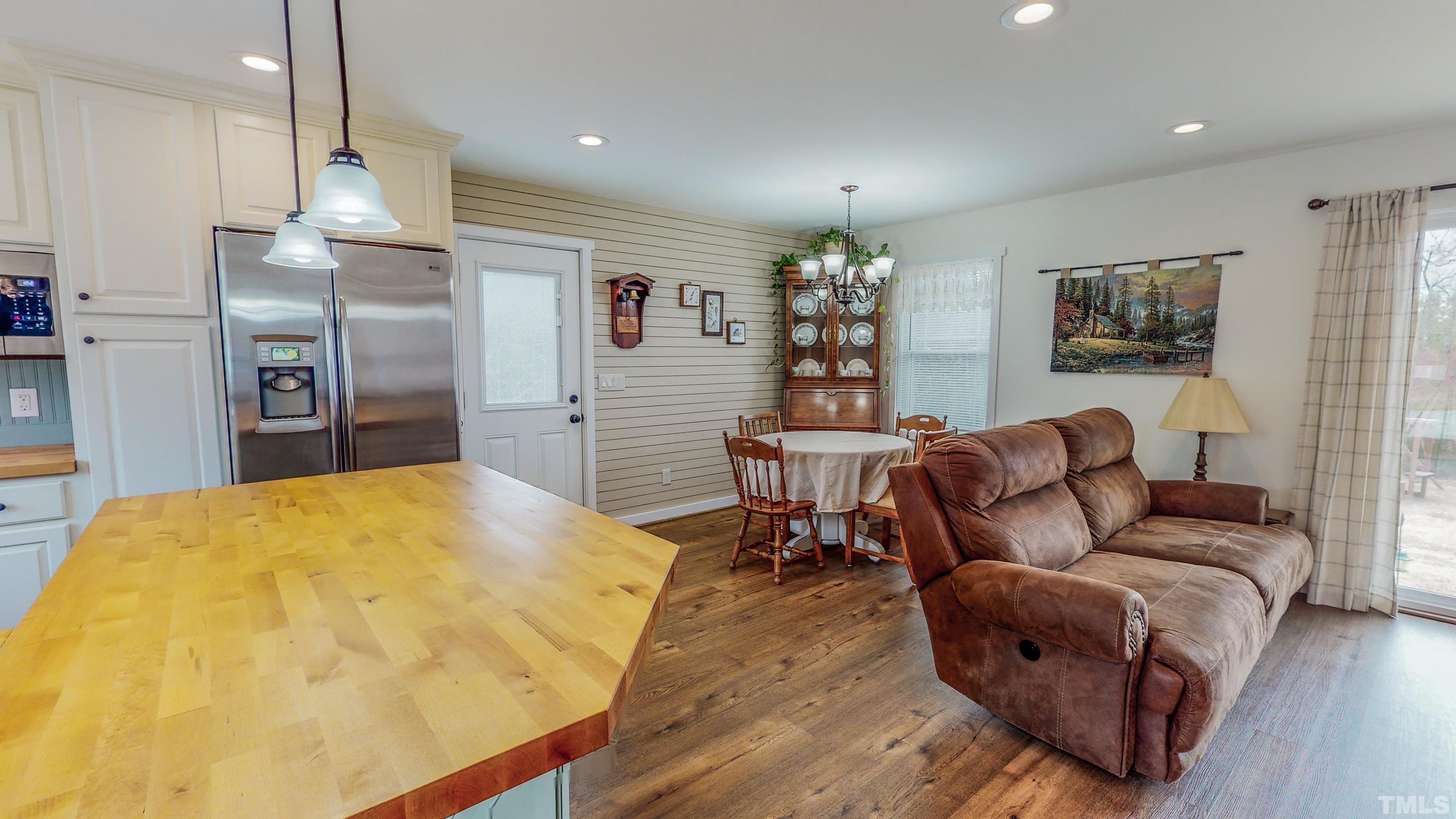 155 Alva Oakley Road Roxboro, NC 27574 - Photo 10 of 42 a living room with furniture a chandelier and a dining room
