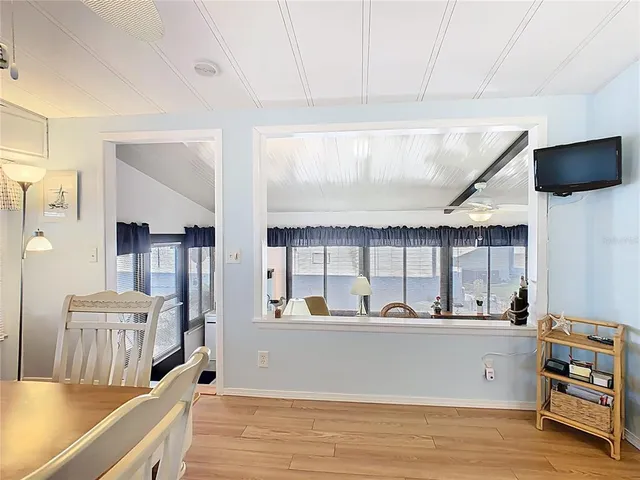 a view of a living room and kitchen with furniture
