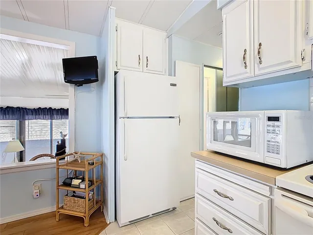 a kitchen with stainless steel appliances a refrigerator and a stove top oven