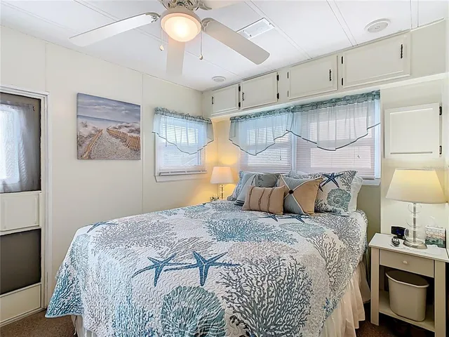 a bedroom with a bed and a lamp