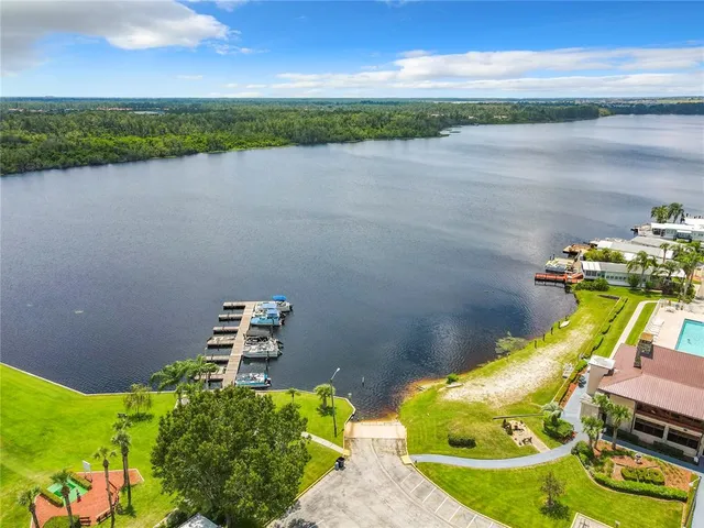 an aerial view of a house with a yard and lake view