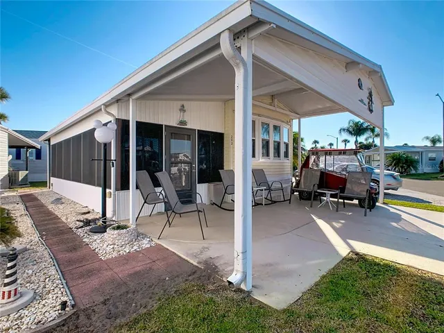 a view of a house with backyard porch and sitting area