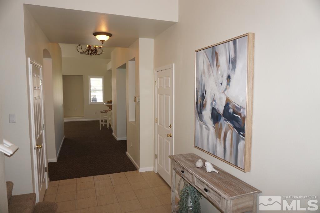 1611 Quail Bar Court Reno, NV 89521 - Photo 2 of 17 a view of a hallway with windows and chandelier