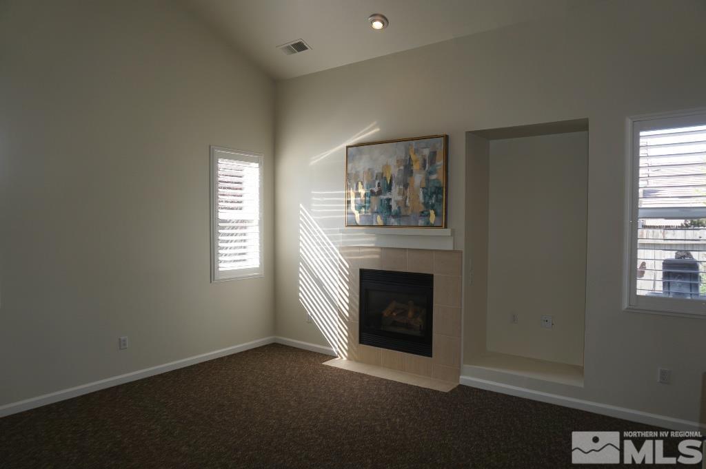 1611 Quail Bar Court Reno, NV 89521 - Photo 3 of 17 an empty room with windows and fireplace
