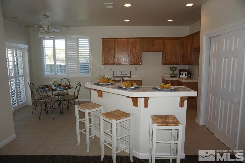 1611 Quail Bar Court Reno, NV 89521 - Photo 4 of 17 a kitchen with stainless steel appliances granite countertop a stove a sink and a refrigerator
