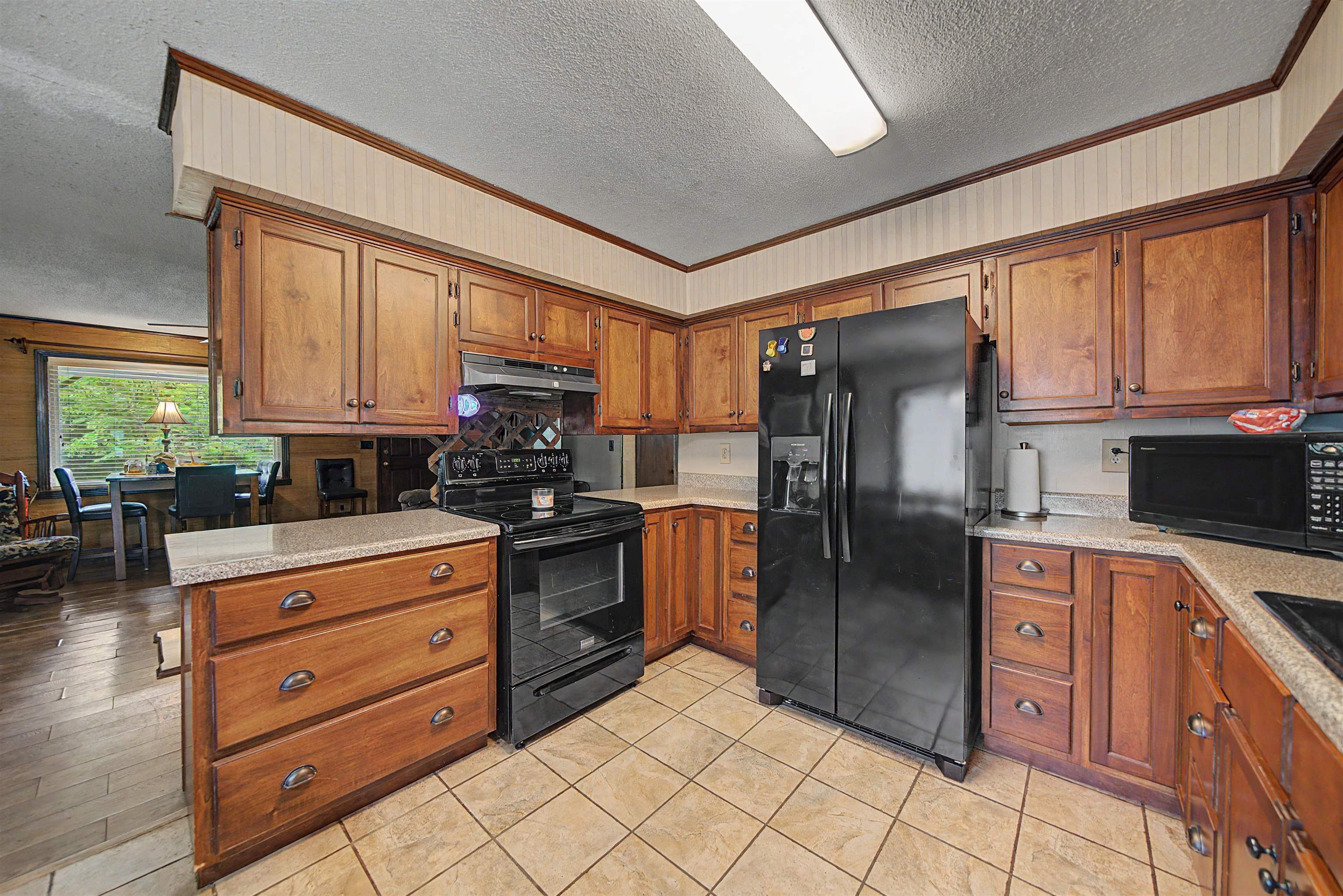 12 Baker Road Selmer, TN 38375 - Photo 16 of 28 a kitchen with stainless steel appliances granite countertop a refrigerator stove and sink