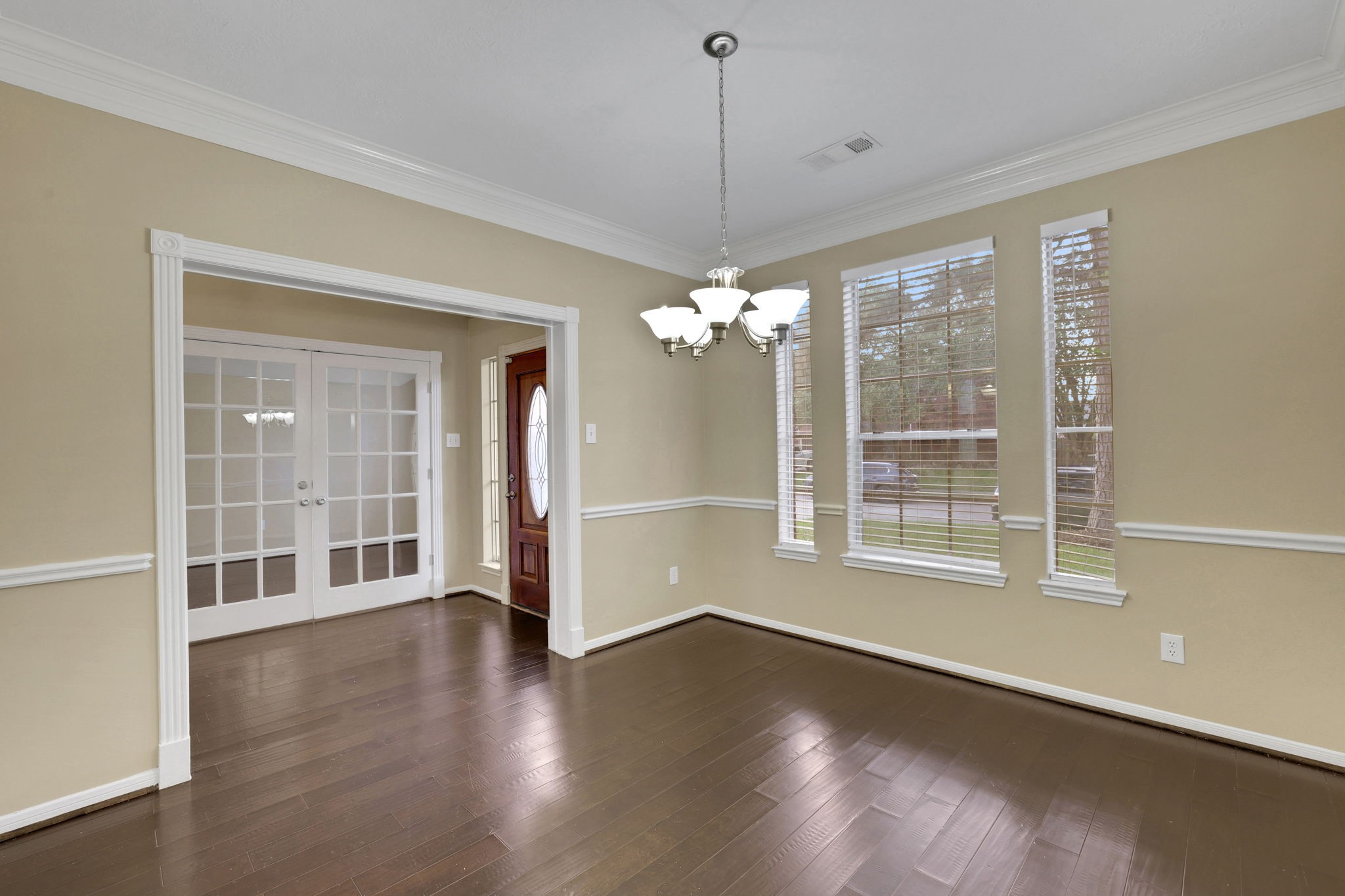 23207 Olive Ridge Court Katy, TX 77494 - Photo 9 of 46 a view of an empty room with wooden floor and a window