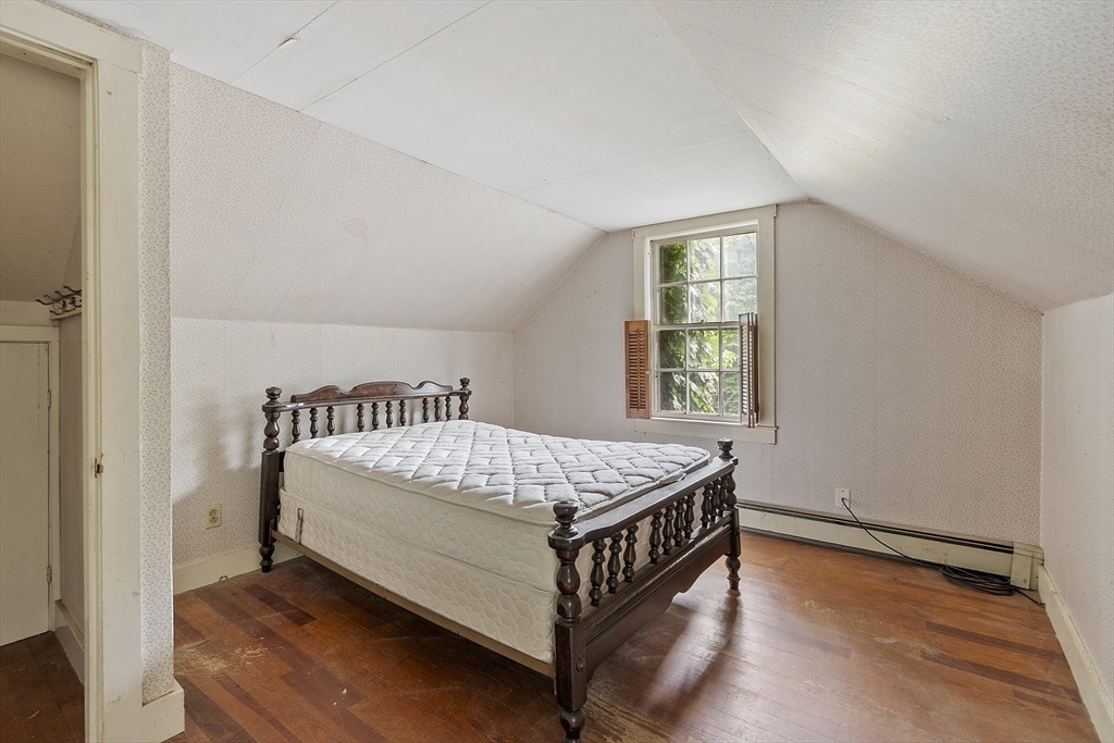 22 Haynes Road Townsend, MA 01469 - Photo 14 of 24 a bed sitting in a bedroom next to a window
