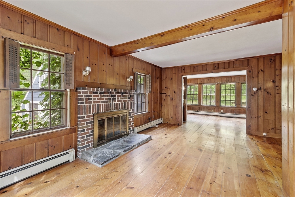 22 Haynes Road Townsend, MA 01469 - Photo 3 of 24 a view of an empty room with wooden floor fireplace and a window