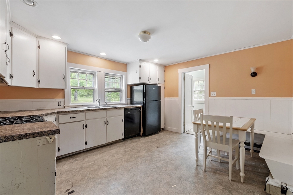 22 Haynes Road Townsend, MA 01469 - Photo 7 of 24 a kitchen with a table chairs refrigerator and cabinets