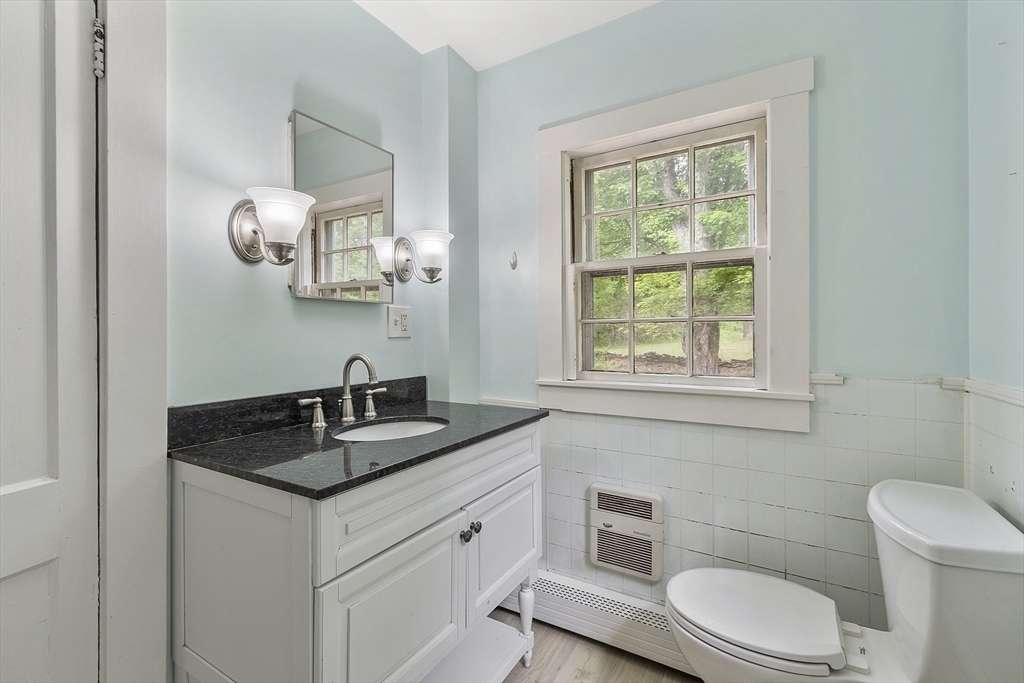 22 Haynes Road Townsend, MA 01469 - Photo 9 of 24 a bathroom with a granite countertop toilet sink and mirror