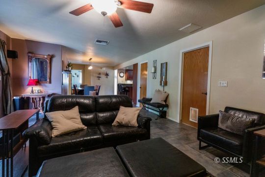 908 North Inyo Street Ridgecrest, CA 93555 - Photo 19 of 46 a living room with furniture and wooden floor