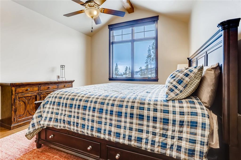 867 Independence Road, Unit 4A Keystone, CO 80435 - Photo 19 of 28 a bedroom with a bed and a chandelier