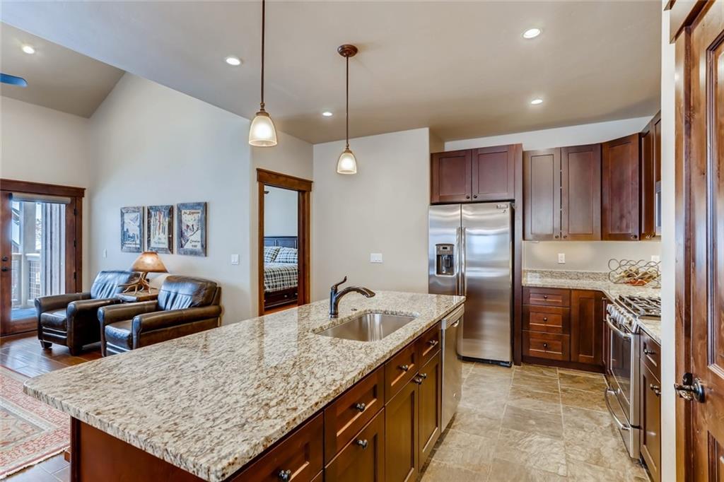 867 Independence Road, Unit 4A Keystone, CO 80435 - Photo 5 of 28 a kitchen with kitchen island granite countertop a sink stove and refrigerator