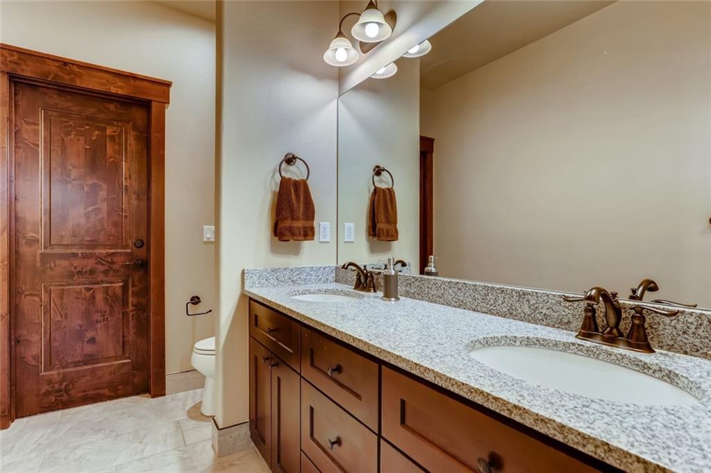 867 Independence Road, Unit 4A Keystone, CO 80435 - Photo 7 of 28 a bathroom with a granite countertop sink and a mirror