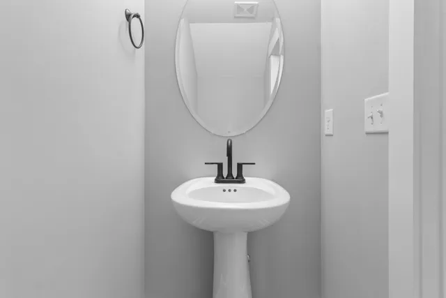 an empty room with windows and ceiling fan view