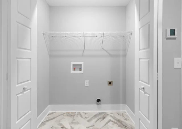 an empty room with a window and a ceiling fan