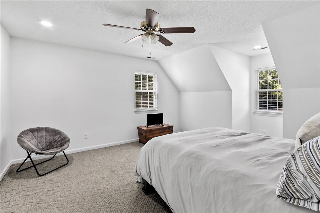 608 Robin Hood Lane Anderson, SC 29621 - Photo 18 of 36 Angled upper-level ceilings and plush wall-to-wall carpeting define this peaceful sleeping space.