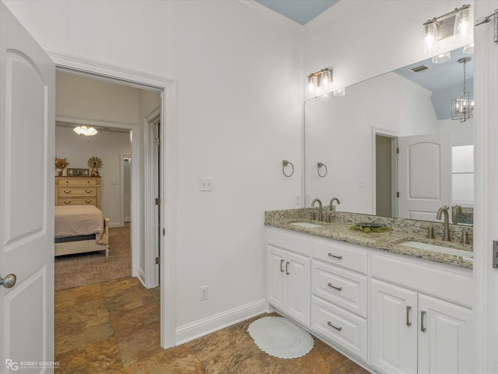 690 Lessie Drive Stonewall, LA 71078 - Photo 18 of 29 Double vanity with stone-finish countertop, two undermount sinks, and brushed nickel hardware