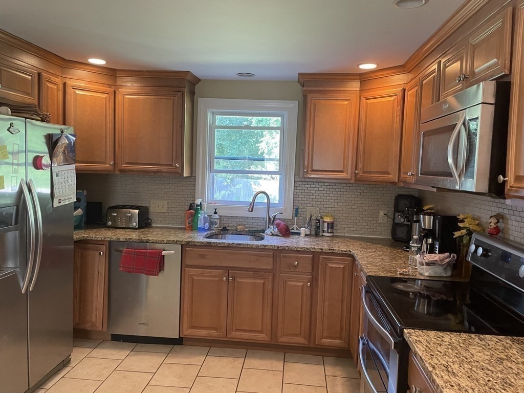 20 Johnson Street Ashland, MA 01721 - Photo 2 of 24 a kitchen with stainless steel appliances granite countertop a stove a sink dishwasher and a refrigerator