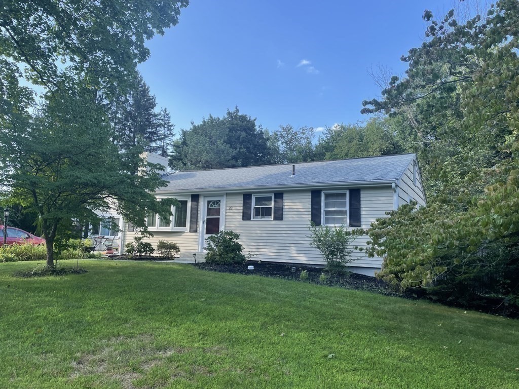 20 Johnson Street Ashland, MA 01721 - Photo 24 of 24 a front view of a house with a garden and trees