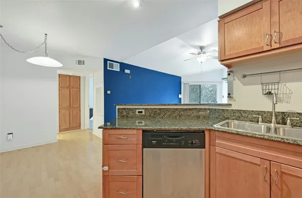 a kitchen with cabinets appliances and a counter space
