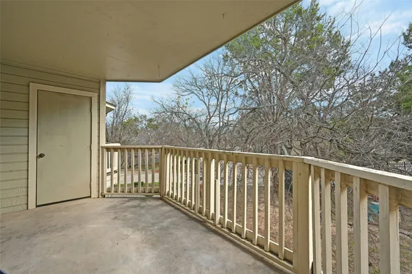 a view of balcony with wooden fence and floor