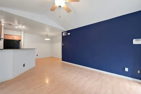 a view of an empty room with a fireplace