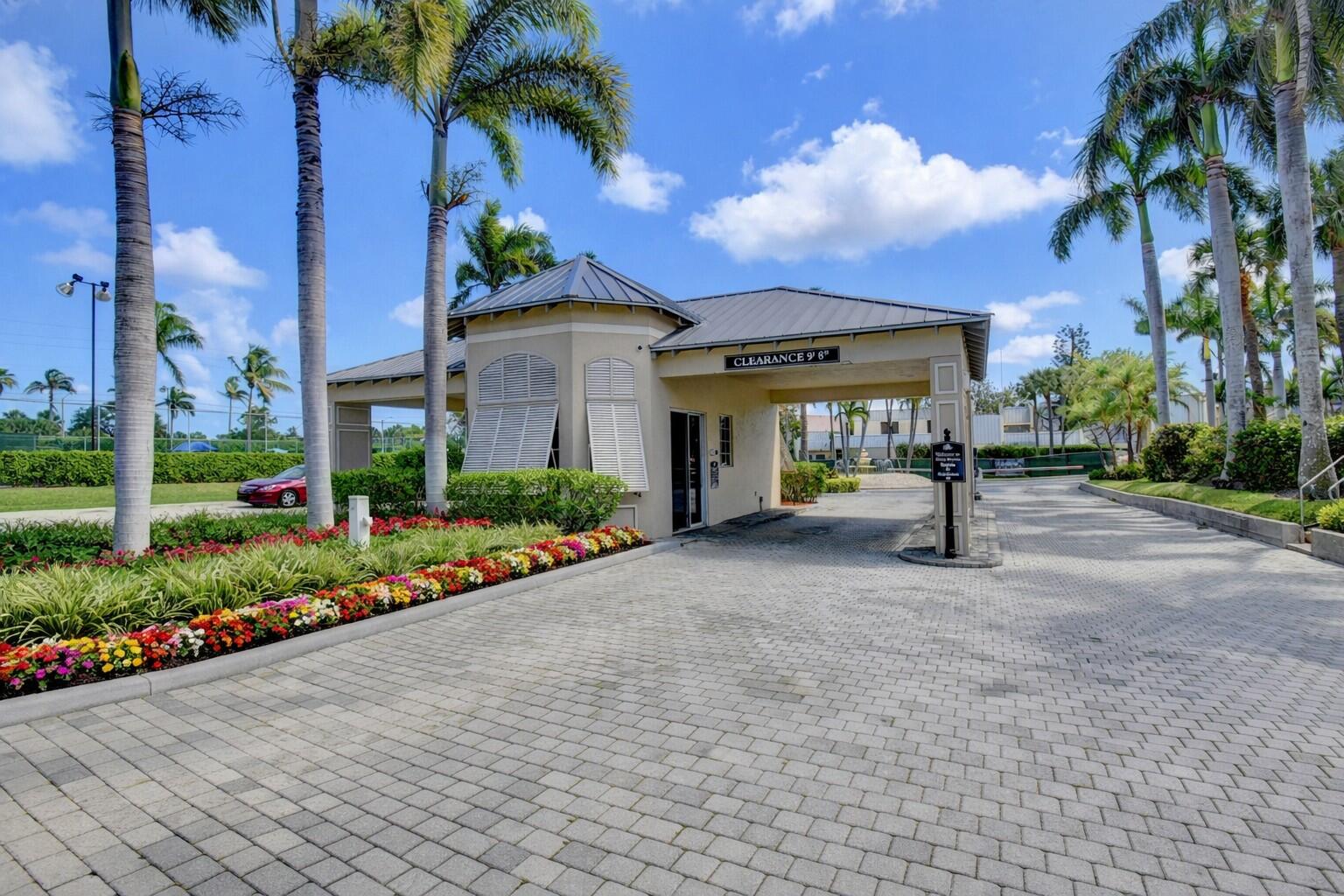 a front view of a house with a yard and potted plants