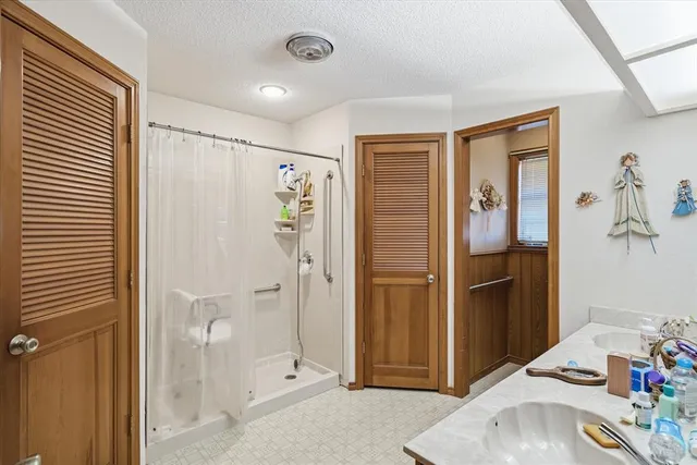 a bathroom with a shower and a sink
